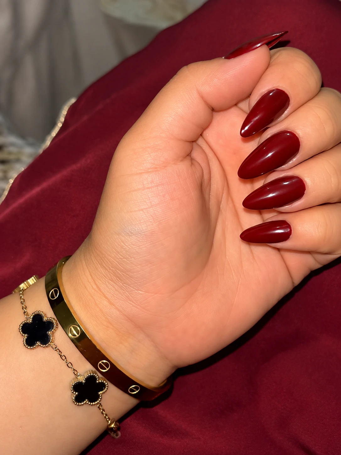 Cherry Red Almond Nails with Gold-Tone Jewelry